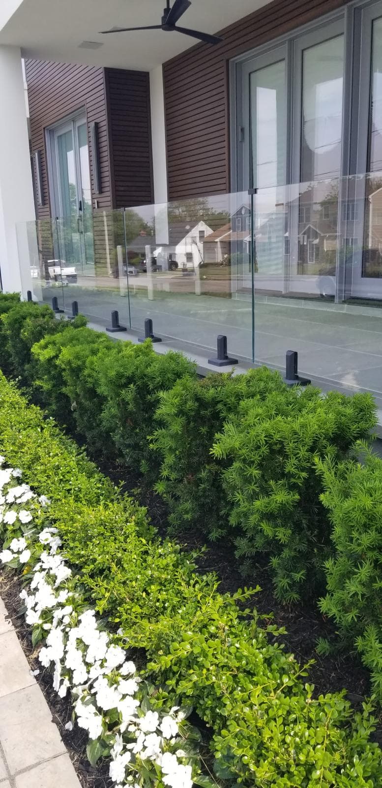 outdoor glass balcony railing w/ landscaping