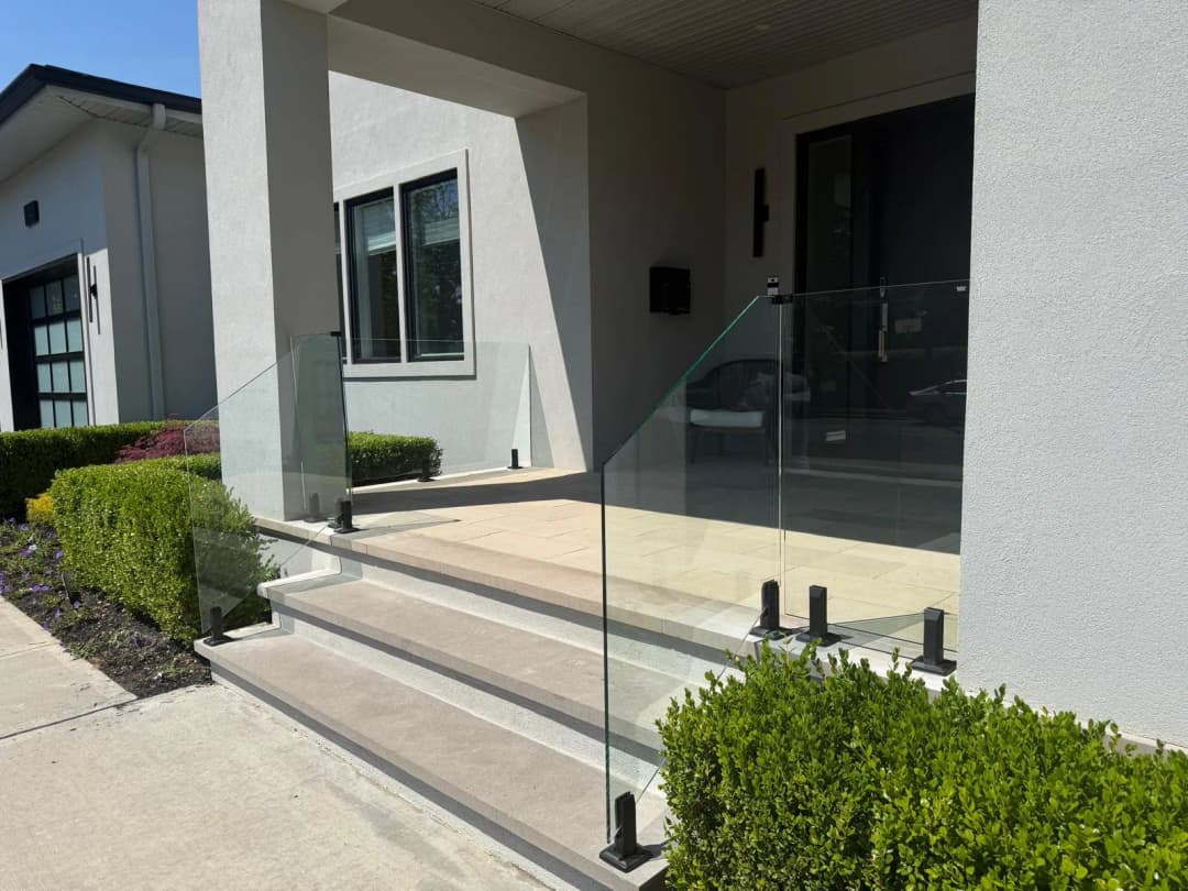 front entry glass railing on steps, landscaping