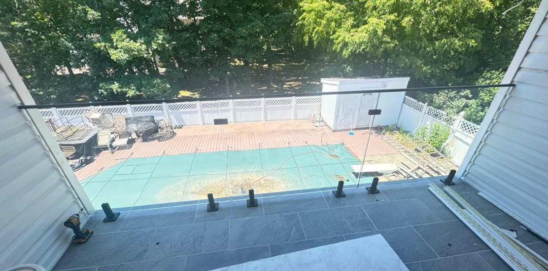 pool deck view through glass railing
