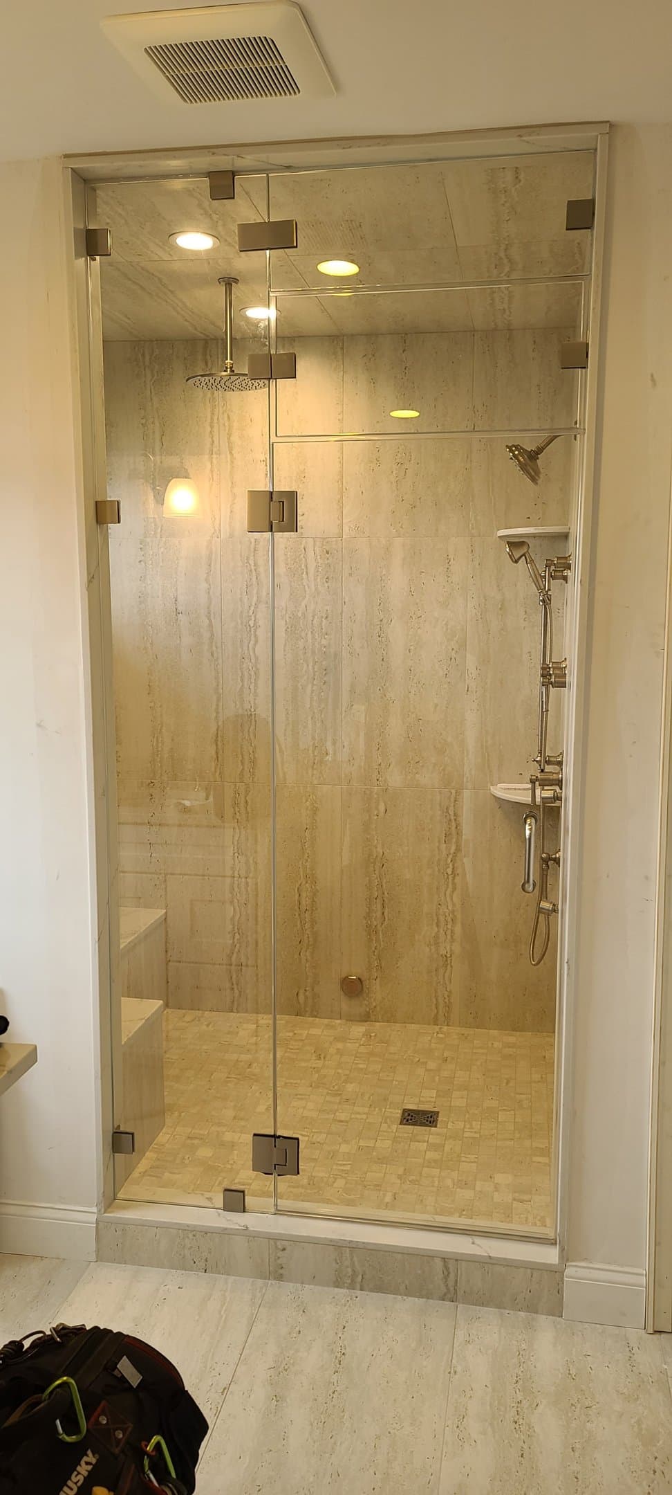 travertine steam shower, gold fixtures