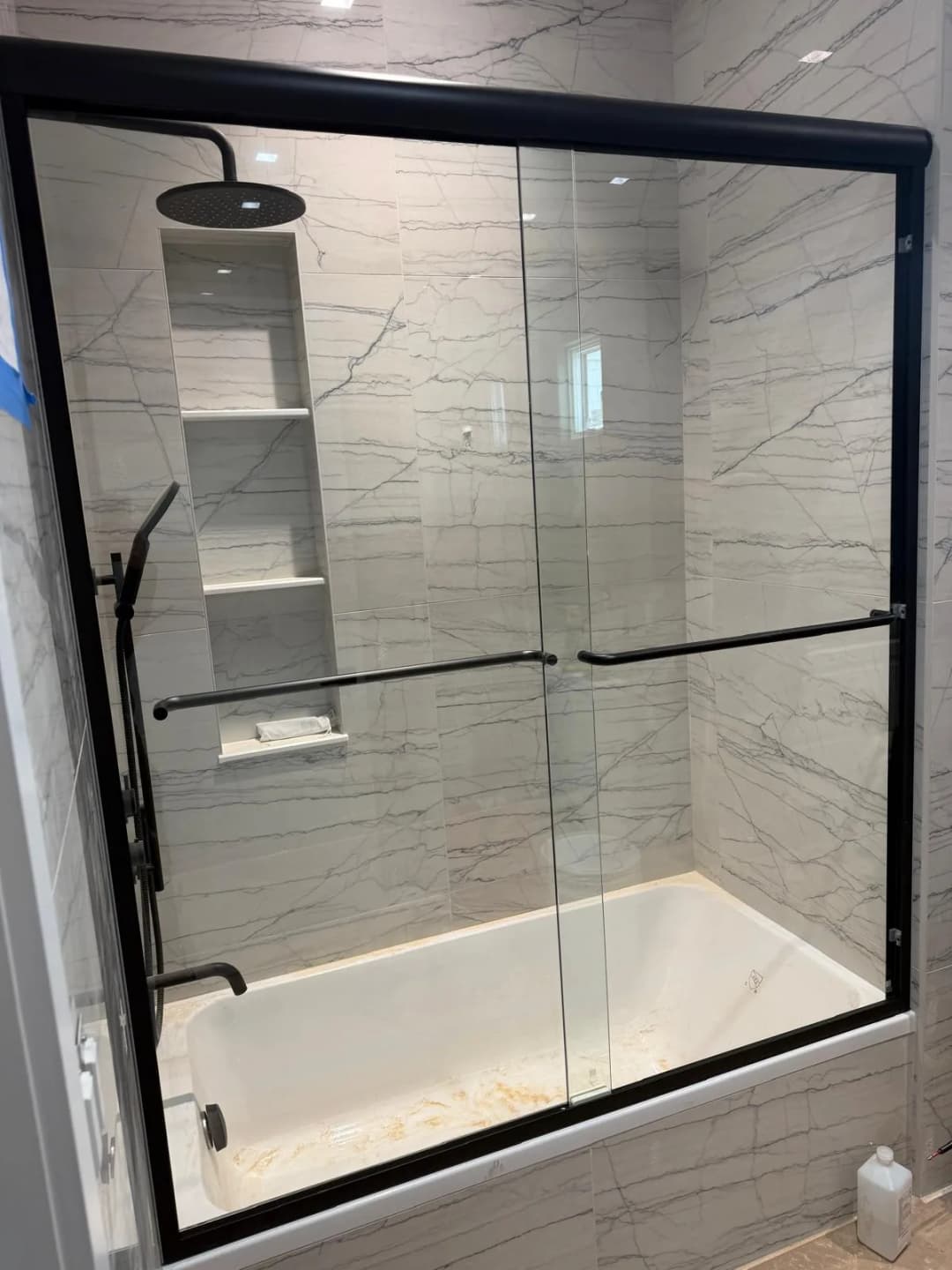 black-framed frameless shower over tub
