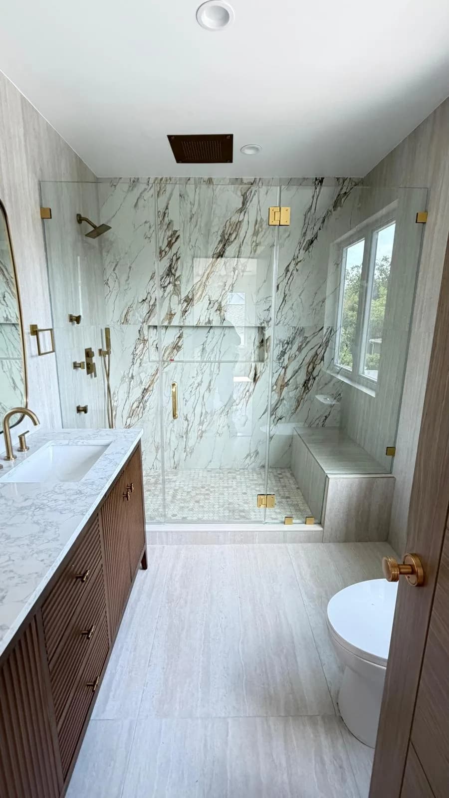 luxury shower, brown/gold veined marble, black rainhead