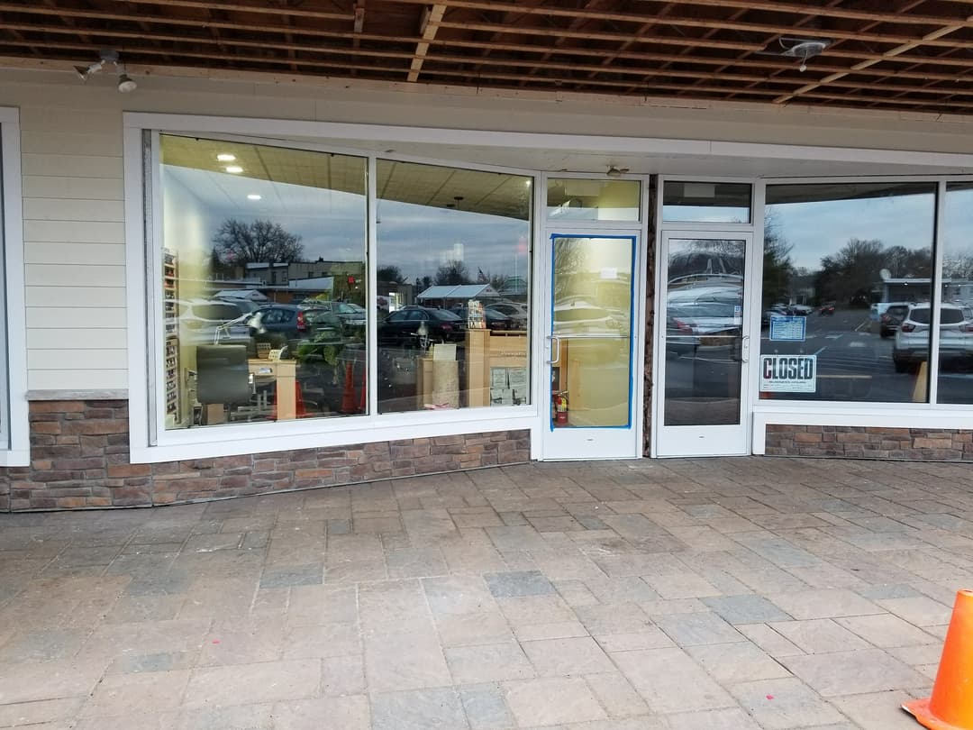 nail salon storefront glass, CLOSED sign visible